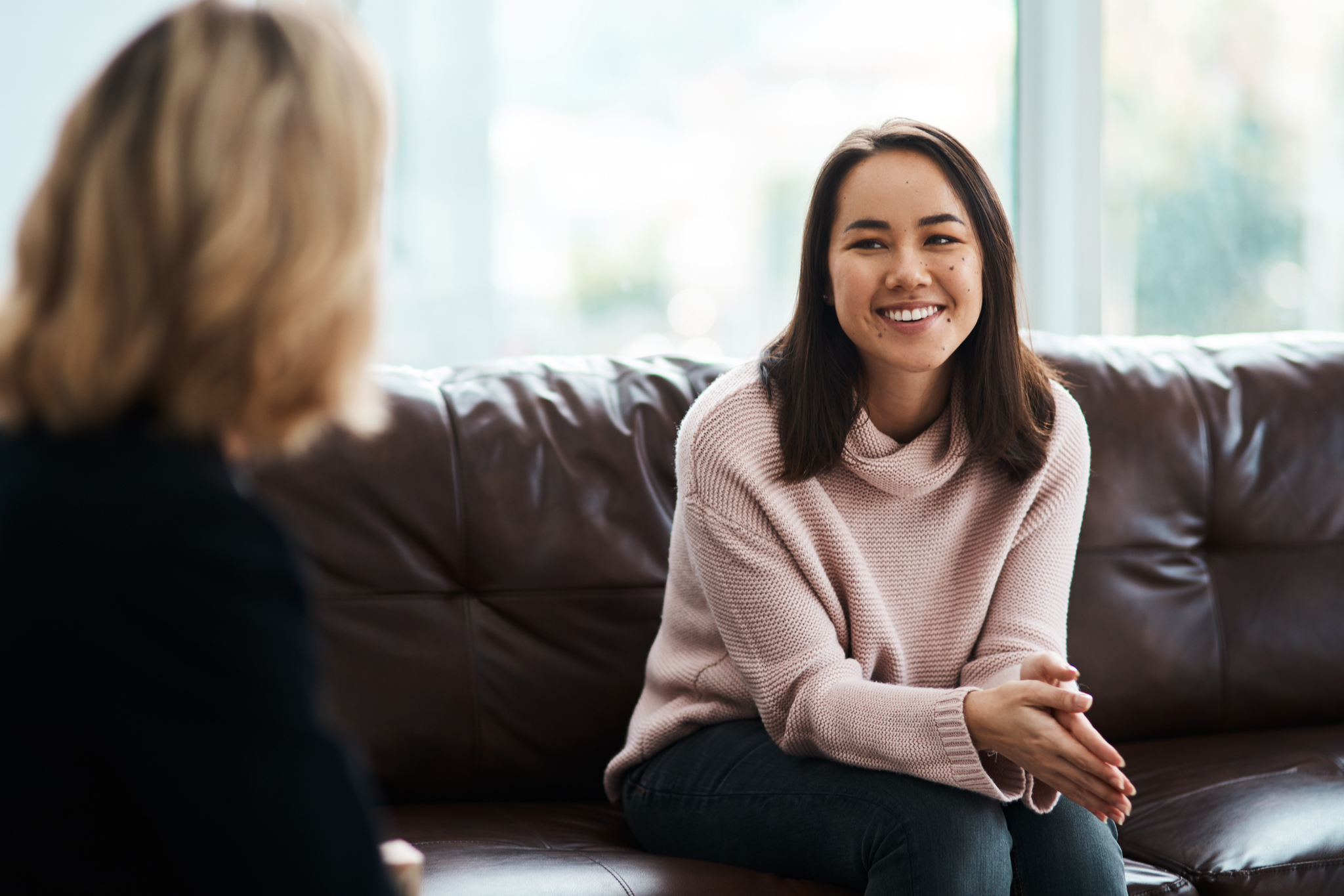 therapist meeting with woman in a cozy office about mental health and addiction issues better understanding her future and best ways to stay sober